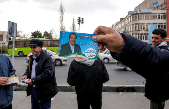‘중동의 맹주’ 이란이 오는 21일 총선을 앞두고 선거 정국에 들어갔다. 지난 15일(현지시간) 테헤란에서 한 남성이 선거 포스터를 들고 있다. 테헤란 AFP 연합뉴스