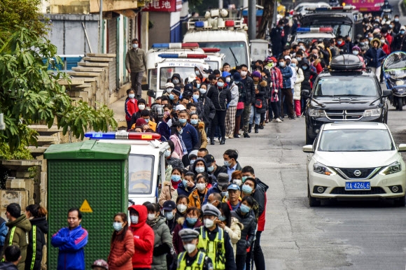 29일 중국 난징에서 시민들이 마스크를 사기 위해 줄을 서고 있다. AP통신