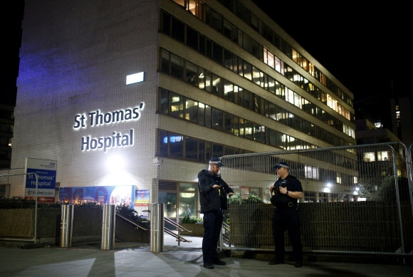보리스 존슨 영국 총리의 코로나19 증상이 나아지지 않아 집중 치료 병상으로 옮겨진 런던의 세인트 토머스 병원 바깥을 경찰관들이 경호하고 있다. 런던 로이터 연합뉴스 