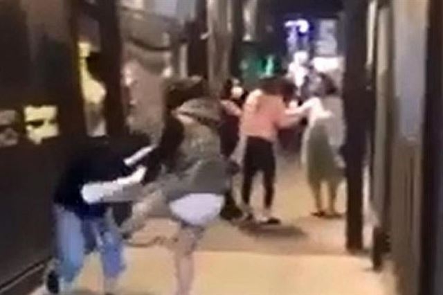호주 여성이 호주 멜버른 중심가에서 싱가포르 여성의 머리채를 잡아당기며 발로 때리고 있다.  스트레이츠타임스.