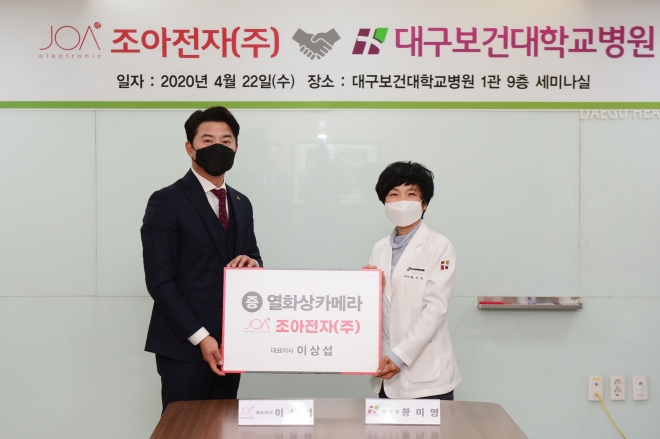 이상섭 조아전자 대표(왼쪽)가 22일 오전 10시 대구보건대학교병원 1관 9층 세미나실에서 열화상 카메라 기증식을 개최한 가운데 황미영 병원장(오른쪽)과 기념촬영을 하고 있다.