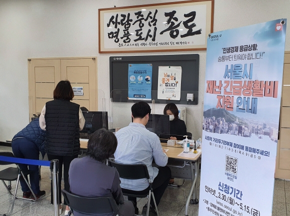 23일 서울 종로구 종로 1,2,3,4동 주민센터에서 지역주민들이 재난지원금 신청을 하고 있다. 2020.4.23   이종원 선임기자 jongwon@seoul.co.kr