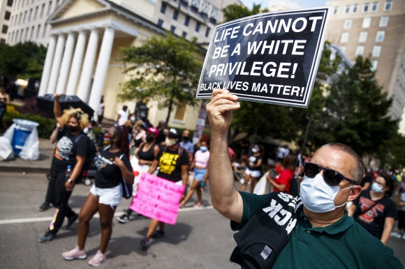 미국 전역에서 인종차별에 항의하는 시위가 펼쳐진 6일(현지시간) 워싱턴 DC의 백악관 근처에서 시위 참가자들이 ‘흑인목숨도소중하다(Black Lives Matter)’ 구호가 적힌 플래카드를 내보이며 행진하고 있다. 워싱턴 DC EPA 연합뉴스