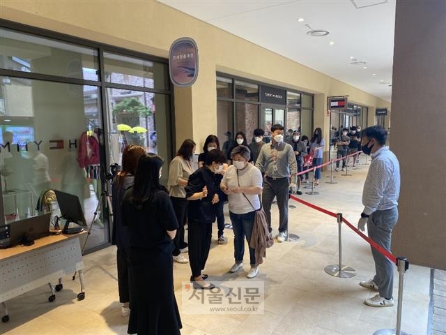 25일 오전 면세점 재고 상품을 판매하는 롯데프리미엄아울렛 기흥점에 대기표를 받은 고객들이 행사장 안으로 들어가기 위해 길게 줄을 서 있다.