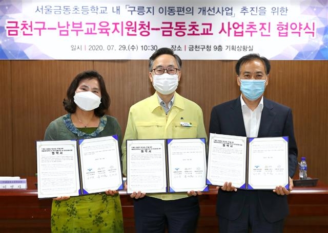 지난 29일 금천구청에서 열린 이동편의 개선사업 협약식에서 이영자(왼쪽부터) 금동초등학교장, 유성훈 금천구청장, 김재환 서울남부교육지원청 교육장이 기념사진을 촬영하고 있다. 금천구 제공