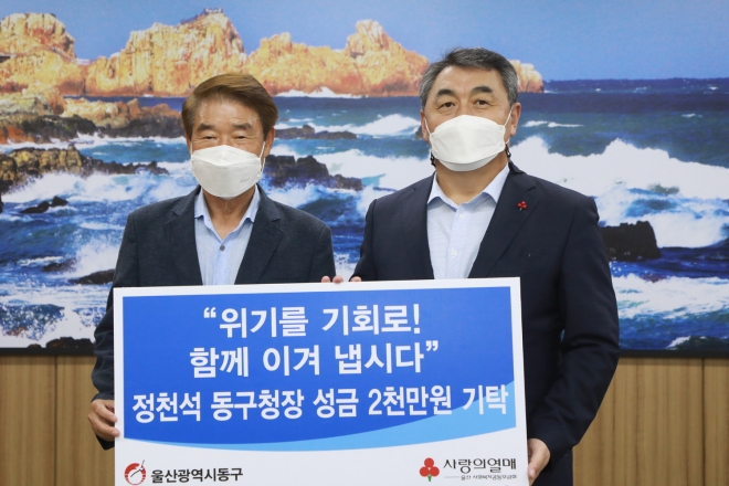 정천석(왼쪽) 울산 동구청장이 24일 구청장실에서 이웃돕기 성금 2000만원을 기탁한 뒤 기념촬영을 하고 있다. 울산 동구 제공.