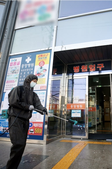 14일 오전 집단감염이 발생한 광주 서구 중앙병원 주변에서 방역당국 관계자가 소독을 하고 있다. 연합뉴스 