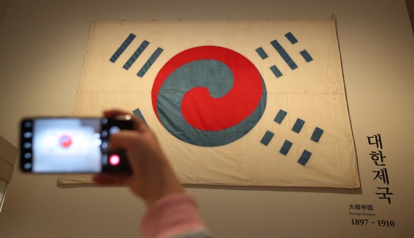 서울 용산구 국립중앙박물관을 찾은 관람객들이 23일 오전 ‘데니태극기’를 관람하고 있다. 국립중앙박물관은 제102주년 삼일절을 맞아 23일부터 2주간 국내에서 가장 오래된 태극기인 ‘데니 태극기’를 공개한다고 밝혔다. 2021.2.23 박지환기자 popocar@seoul.co.kr