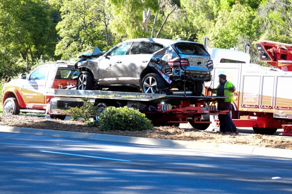 23일(현지시가) 미국 캘리포니아주 로스앤젤레스의 랜초 팔로스버디스 구역에서 발생한 ‘골프 황제’ 타이거 우즈의 자동차 전복 사고 현장에서 우즈가 몰던 SUV 차량이 트럭에 실려 이송되고 있다. AFP 연합뉴스