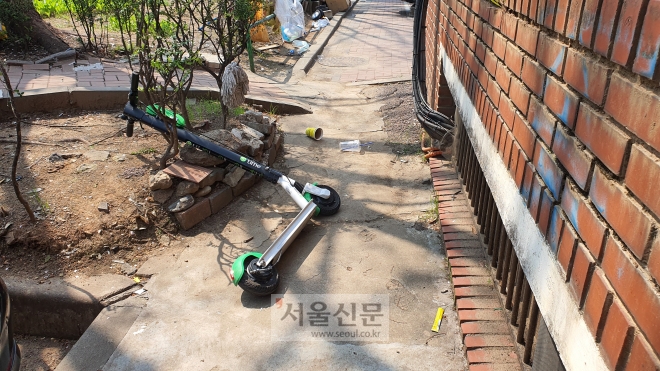 지난 11일 서울 양천구 한 아파트단지 내 좁은 골목 한 켠에 전동킥보드가 쓰러진 채 방치돼 보행자의 통행을 방해하고 있다.