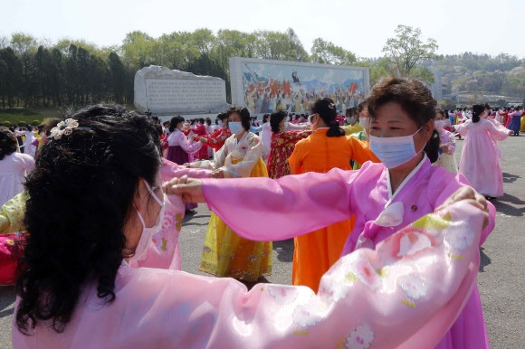 북한 여성들이 15일 고 김일성 주석의 생일(태양절)을 맞아 평양의 개선문 주변에서 춤을 추고 있다.  AP 연합뉴스