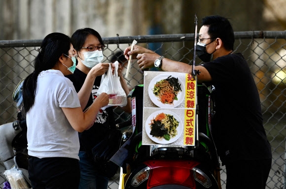 타이완 근로자들이 12일 정부가 코로나19 확산 방지책으로 대규모 모임을 금지하자 점심 도시락을 배달받고 있다. 연합뉴스.