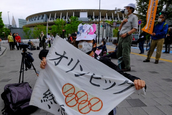 일본 시민들이 18일 올림픽 위원회 본부 앞에서 2020 도쿄 올림픽 개최 반대 시위를 하고 있다. 연합뉴스
