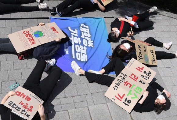 30일 서울 종로구 성균관대학교 인문사회과학캠퍼스 앞에서 대학생기후행동 연대지부 회원들이 ‘2021 P4G 서울 녹색미래 정상회의’에 앞서 ‘탈산소와 탈핵 정치로 기후정의 실현’ 촉구 기자회견을 마친 후 정상회의가 열리는 동대문디자인플라자(DDP)로 행진 중 ‘다이인’ 퍼포먼스를 하고 있다. 2021.5.30 오장환 기자 5zzang@seoul.co.kr