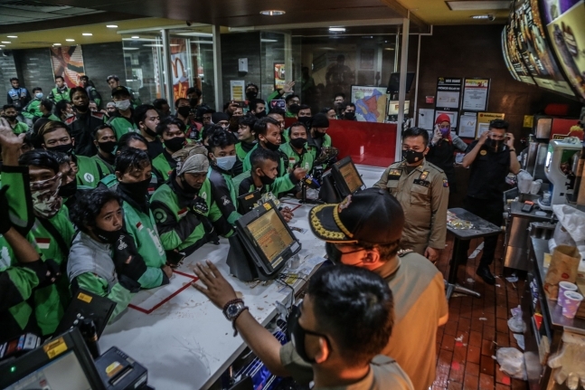 자카르타 남부 외곽 도시 보고르의 한 맥도날드 매장에 배달기사 수십여명이 BTS 세트를 사기 위해 몰린 모습. 매장 바깥에까지 줄을 서 있다. AFP 연합뉴스