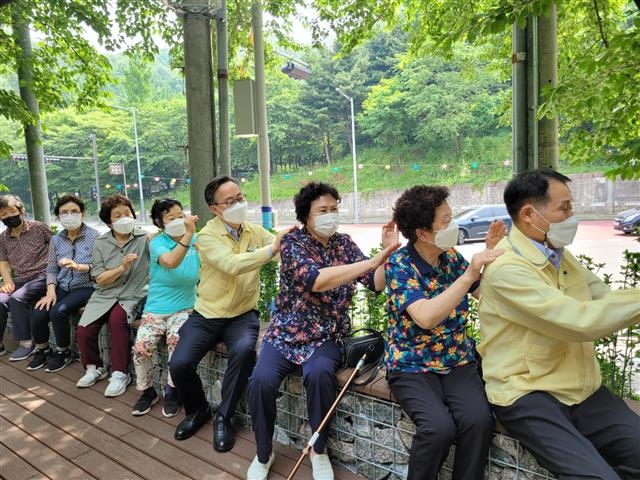 유성훈(오른쪽 네 번째) 금천구청장이 시흥2동 삼각공원에서 어르신들과 체조를 하며 소통의 시간을 갖고 있다. 금천구 제공