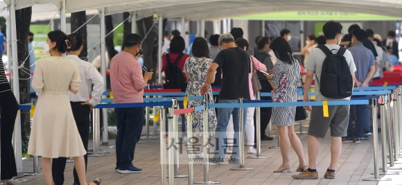 15일 서울시청 선별진료소를 찾은 시민들이 코로나19 검사를 받기 위해 줄을 서 있다. 2021.7.15 박지환기자 popocar@seoul.co.kr