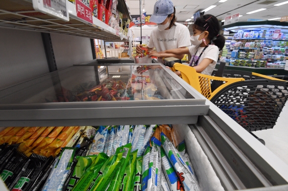 코로나 4차 유행에 따른 ‘집콕’ 확산과 폭염이 계속되면서 아이스크림 업계가 ‘반짝 호황’을 맞고 있는 가운데 20일 서울의 한 마트를 찾은 어린이가 아이스크림을 고르고 있다. 2021.7.20 도준석 기자 pado@seoul.co.kr
