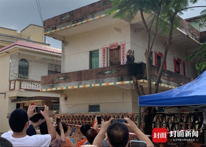 관광객들이 중국 광둥성 취안훙찬의 집 앞에서 사진을 찍고 있다.