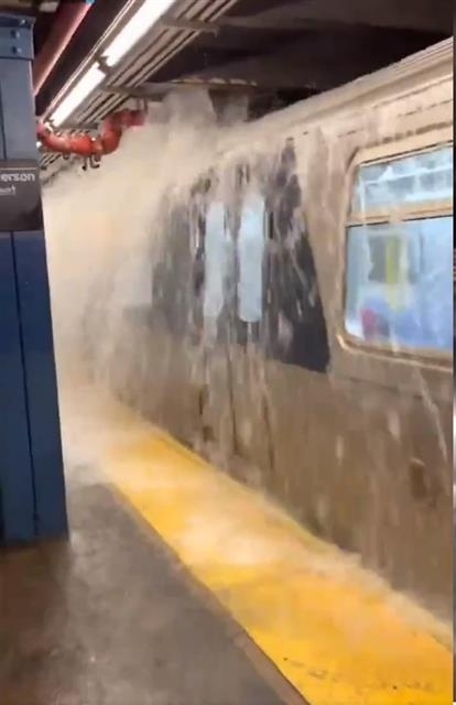 허리케인 아이다가 미국 북동부에 폭우·침수 피해를 입힌 1일(현지시간) 뉴욕 브루클린 역사 승강장에 들어선 지하철 위로 물폭탄이 떨어지고 있다. 지하철역 계단을 타고 급류가 형성되고, 객차 지붕 위 천장 배관에서 물이 폭포처럼 쏟아졌다. 트위터 캡처