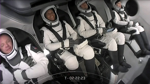 스페이스엑스에서 찍은 인터넷 생방송의 캡처 화면으로 민간인으로만 구성된 크루드래건 선원 4명이 발사 직전 안전벨트를 매고 좌석에 앉은 모습이 보인다. 스페이스엑스 제공