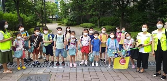 서울 성동구 워킹스쿨버스 교통안전지도사가 아이들의 등·하원을 안전하게 지도하고 있다. 성동구 제공