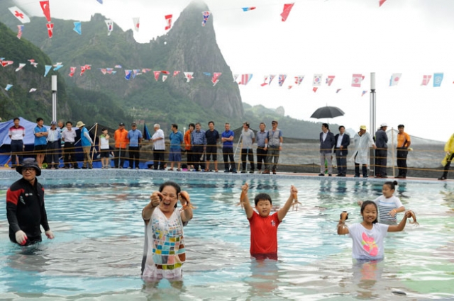 ‘울릉도 오징어 축제’ 참가자들이 오징어 맨손잡이 체험을 하며 즐거워하고 있다. 울릉군 제공