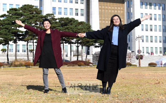 이안소영(왼쪽) 여성환경연대 상임대표와 안현진 활동가가 18일 서울 여의도 국회 앞에서 두 팔을 활짝 펼쳤다. 2017년 일회용 생리대의 유해성을 공론화하고 4년여를 끈 소송 끝에 승소한 뒤 되찾은 웃음이다. “에코페미니즘 중에서도 여성과 환경운동 모두에서 소외되던 이슈가 ‘생리대’였다고 생각했다”는 이들은 “그것이 누군가에게는 급박하고 중요한 사안일 수 있고, 우리는 그런 것들을 챙기고 있다”고 말했다. 오장환 기자 5zzang@seoul.co.kr