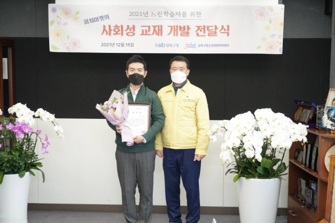 이승로(오른쪽) 성북구청장이 지난 15일 열린 ‘느린학습자를 위한 사회성기술 교재 전달식’에 참석해 기념촬영을 하고 있다. 성북구 제공