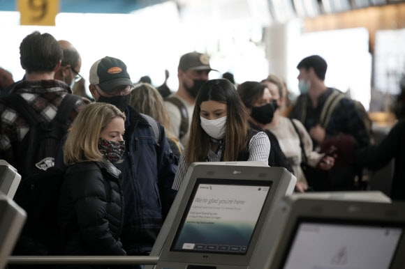 지난 24일(현지시간) 미국 덴버 국제공항에서 탑승객들이 마스크를 쓰고 있다. AP