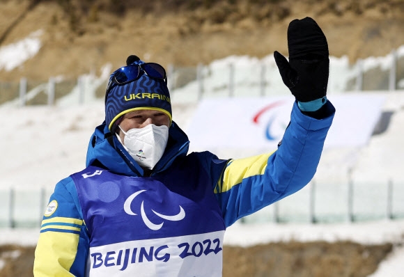 그리고리 보브친스키가 5일 중국 허베이성 장자커우에서 열린 2022 베이징동계패럴림픽 바이애슬론 남자 스프린트 입식 6㎞에서 금메달을 차지한 후 시상식에서 손을 흔들고 있다. 장자커우 로이터 연합뉴스