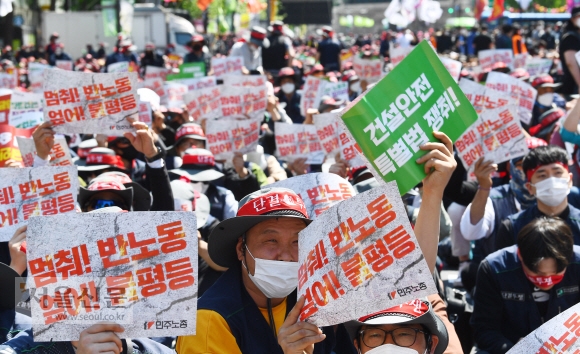 1일 오후 서울 중구 세종대로에서 민주노총 조합원들이 2022 세계 노동자 대회에 맞춰 차별 없는 노동권을 요구하는 손팻말을 들고 있다. 안주영 전문기자