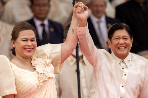 페르디난드 마르코스(오른쪽) 대통령과 사라 두테르테(왼쪽) 부통령이 30일 필리핀 마닐라 국립박물관에서 열린 취임식에서 손을 맞잡고 있다. 마닐라 로이터 연합뉴스