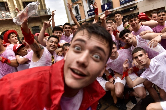 스페인 팜플로나에서 2년만에 재개된 페르민 축제에 참여한 시민들이 추피나소 로켓 발사식 중 카메라에 반응하고 있다. 2022.07.06 AP연합뉴스
