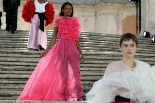 A model wears a creation as part of the Valentino women‘s Fall-Winter Haute Couture 2022-23 collection, unveiled in Rome’s Spanish Steps, Friday, July 8, 2022. (AP Photo/Gregorio Borgia)