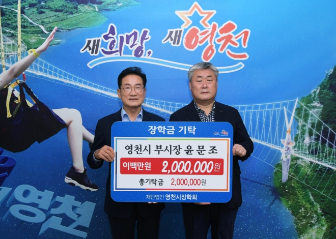 윤문조(오른쪽) 영천부시장이 최기문 영천시장에게 장학금 200만원을 전달했다.영천시청
