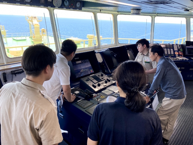 HD현대 아비커스의 자율운항 2단계 솔루션 하이나스2.0이 선박에서 구현되는 모습을 지켜보는 승무원과 직원들. 아비커스 제공