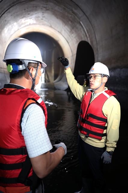 이기재(오른쪽) 양천구청장이 당선인 시절인 지난 6월 20일 지하 40m의 신월빗물저류배수시설을 찾아 현장 관리자에게 설명을 듣고 있다. 양천구 제공