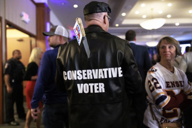 A supporter wears a “Conservat