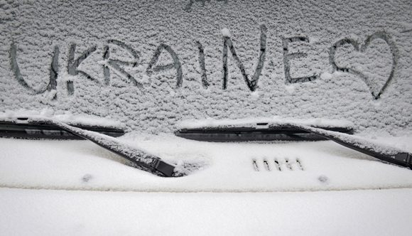 17일(현지시간) 우크라이나 수도 키이우에 첫눈이 내린 가운데, 누군가 자동차 유리창에 ‘우크라이나’라는 글자와 하트를 그려 넣었다. 2022.11.17  AP 연합뉴스