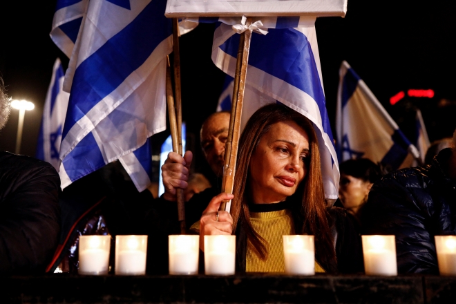 이스라엘 텔아비브에서 28일(현지시간) 열린 사법개혁 반대 시위 도중 시위 참가자들이 전날 발생한 총격 사건 희생자를 위해 묵념하고 있다. 텔아비브 로이터 연합뉴스