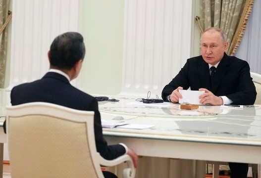 푸틴(오른쪽) 대통령이 22일(현지시간) 크렘린궁에서 왕이 위원과 가깝게 마주 앉아 대화를 나누고 있다.  모스크바 AP 연합뉴스