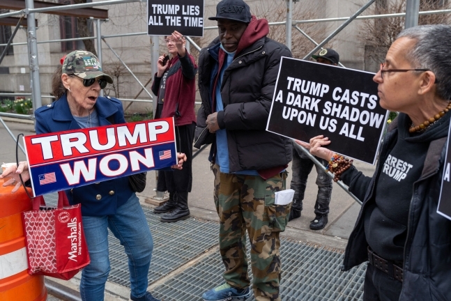트럼프 전 대통령의 기소여부 결정을 앞두고 미국 뉴욕 카운티 형사법정앞에서 트럼프 지지자와 반 트럼프 시위자가 피켓시위를 하고 있다. AFP 연합뉴스