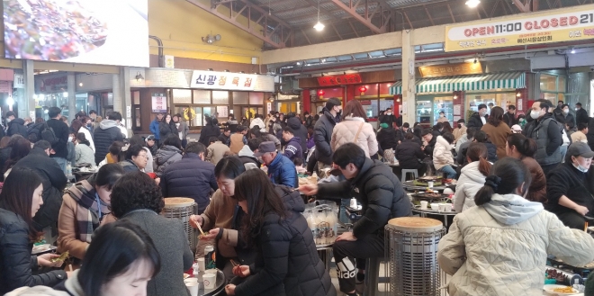 휴장 전 예산시장 광장이 고기를 구워먹는 방문객들로 붐비고 있다. 이천열 기자