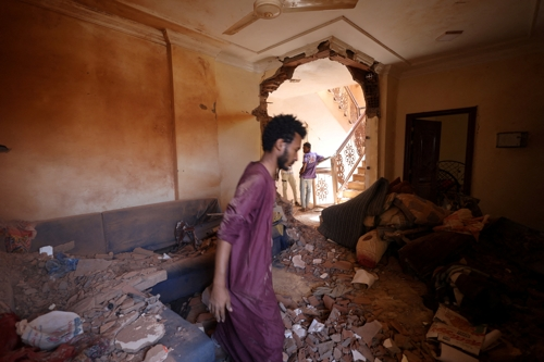 17일(현지시간) 정부군과 준군사조직 신속지원군(RSF)간 무력 충돌이 이어지고 있는 북아프리카 수단 수도 하르툼에서 한 남성이 파괴된 자신의 집을 둘러보고 있다. 하르툼 로이터 연합뉴스