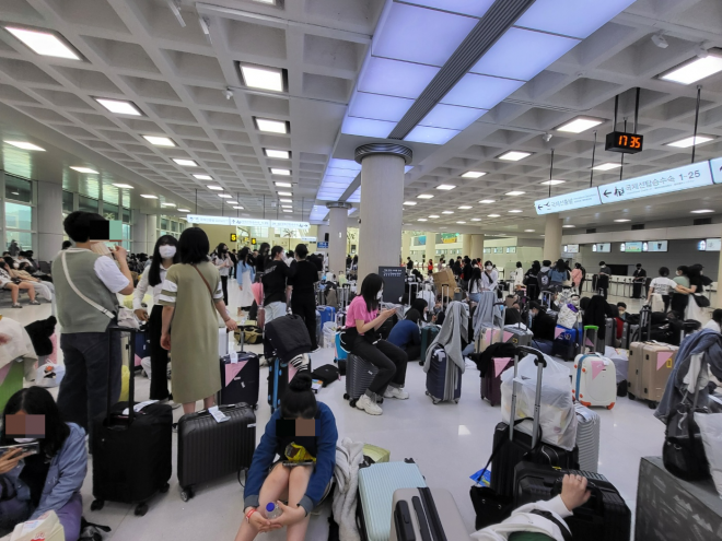 4일 제주로 수학여행을 온 학생들이 항공편들이 줄줄이 결항되자 수학여행단이 한꺼번에 몰려 출발장이 혼잡을 이뤘다. 사진은 혼잡을 피하기 위해 국제선쪽으로 이동한 일부 여행단들이 하루 더 묵었던 숙소에 체류하기 위해 전세버스가 오기만을 손꼽아 기다리고 있다.  제주 강동삼 기자