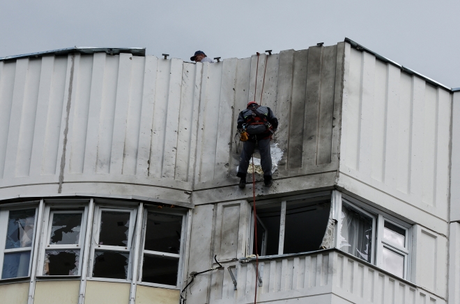 30일(현지시간) 러시아 수도 모스크바에서 근로자들이 드론 공격으로 파손된 주거건물 지붕을 수리하고 있다. 2023.5.30 로이터 연합뉴스