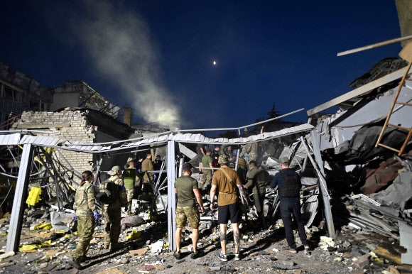 용병 반란이 진정된 러시아군 미사일이 우크라이나 동부 도네츠크주의 크라마토르스크의 식당과 주택이 들어선 건물을 타격, 건물이 무너져 많은 사상자가 발생한 가운데 구조대원들이 잔해 더미 속에서 생존자를 찾고 있다. 크라마토르스크 AFP 연합뉴스