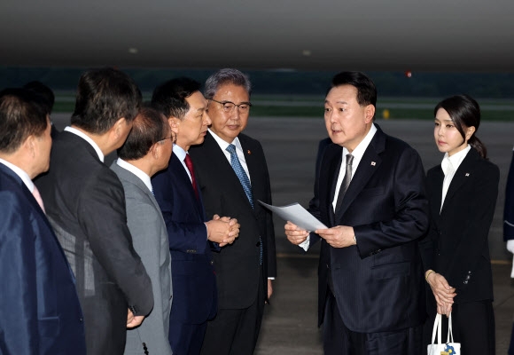 리투아니아에서 열린 나토(북대서양조약기구) 정상회의와 폴란드·우크라이나 방문을 마친 윤석열 대통령이 17일 성남 서울공항을 통해 귀국해 김기현 국민의힘 대표가 준비한 자료를 보며 박진 외교부 장관 등과 대화하고 있다. 2023.7.17 연합뉴스