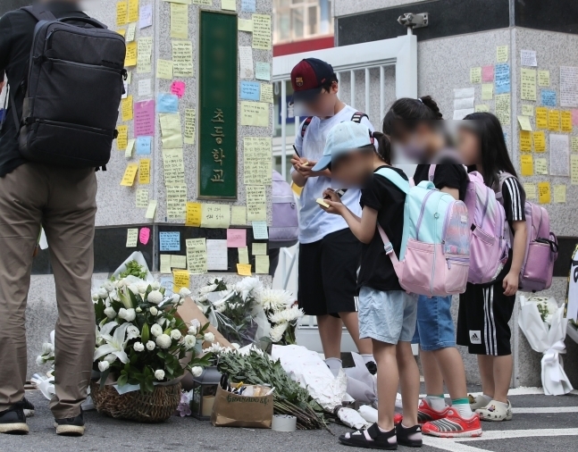 20일 오전 서울 서초구 서이초등학교 정문에서 학생들이 추모 메시지를 적고 있다. 서울시교육청 등에 따르면, 지난 18일 오전 이 학교 1학년 담임인 A씨(23)가 극단적인 선택으로 사망하는 일이 발생했다. 뉴스1